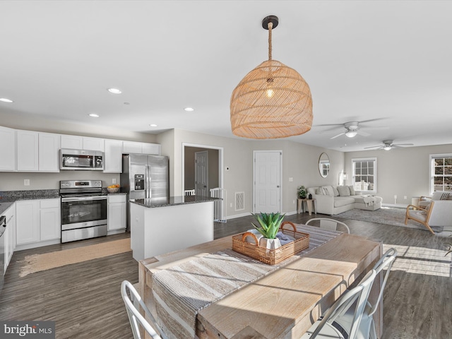 dining area with dark hardwood / wood-style floors and ceiling fan