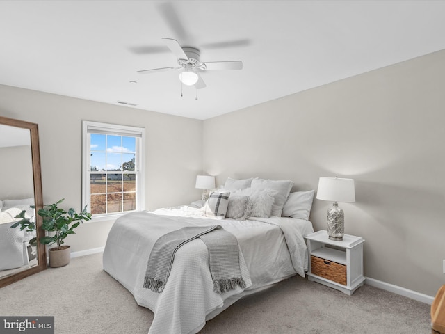 bedroom featuring light carpet and ceiling fan