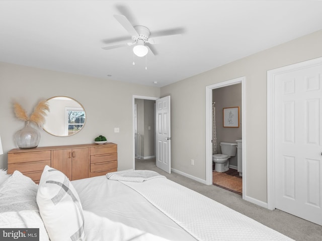 carpeted bedroom with connected bathroom and ceiling fan