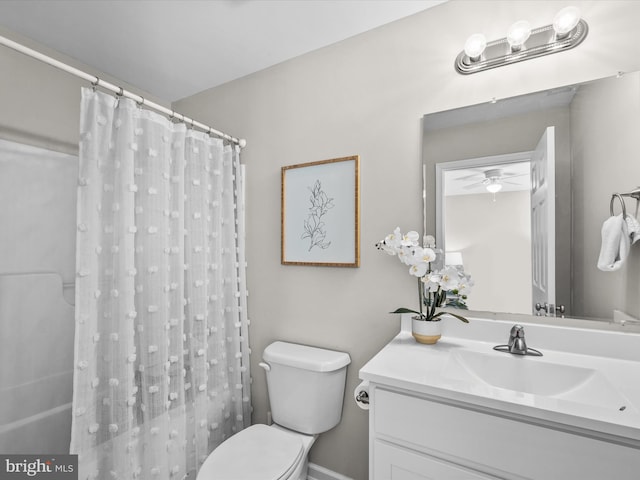 bathroom with vanity, toilet, curtained shower, and ceiling fan