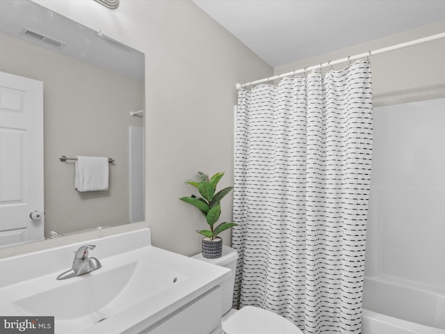 full bathroom with vanity, shower / tub combo, and toilet