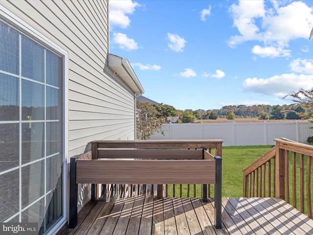 wooden terrace with a yard