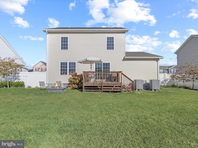 back of house featuring a wooden deck, central AC, and a yard