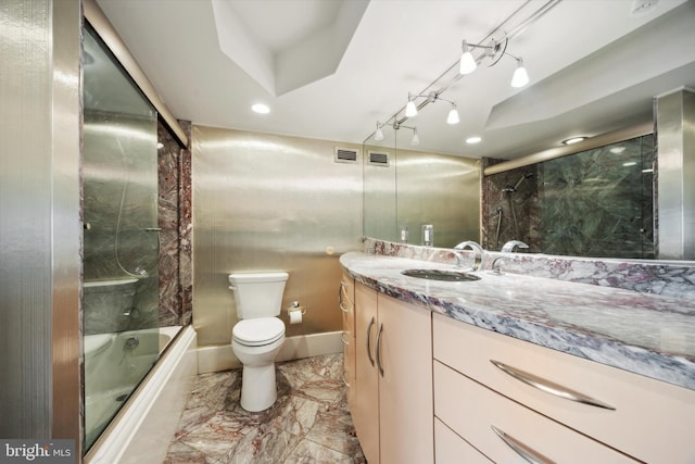 full bathroom with vanity, combined bath / shower with glass door, and toilet