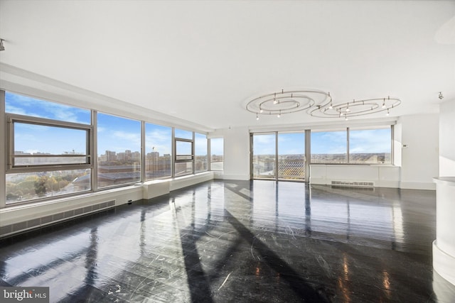 unfurnished room with a chandelier