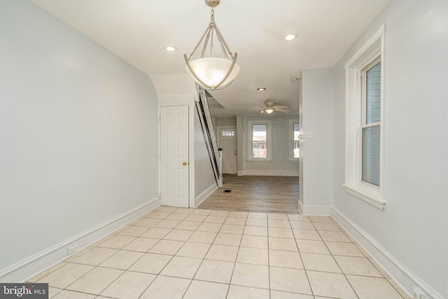 unfurnished dining area featuring ceiling fan and light hardwood / wood-style flooring