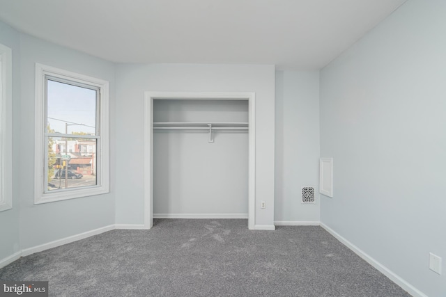 unfurnished bedroom with carpet flooring and a closet