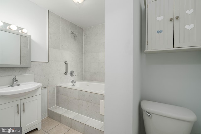 full bathroom with vanity, toilet, tiled shower / bath combo, and tile patterned flooring