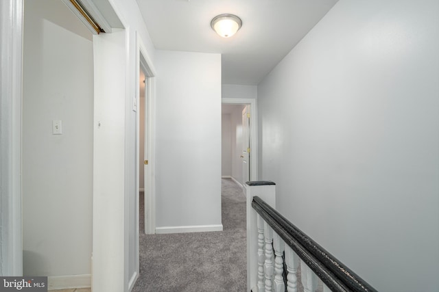 hall with light colored carpet