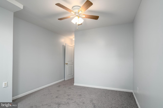 unfurnished room featuring ceiling fan and carpet