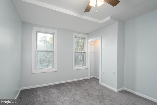 carpeted spare room with ceiling fan