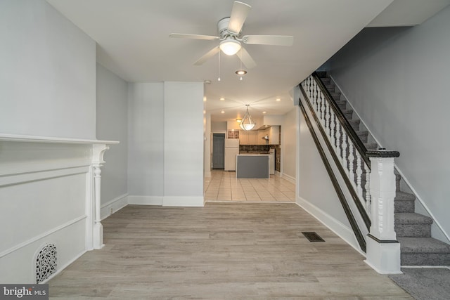 interior space with ceiling fan and light hardwood / wood-style flooring