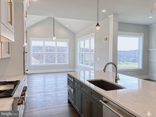 kitchen with dark hardwood / wood-style flooring, lofted ceiling, sink, and pendant lighting