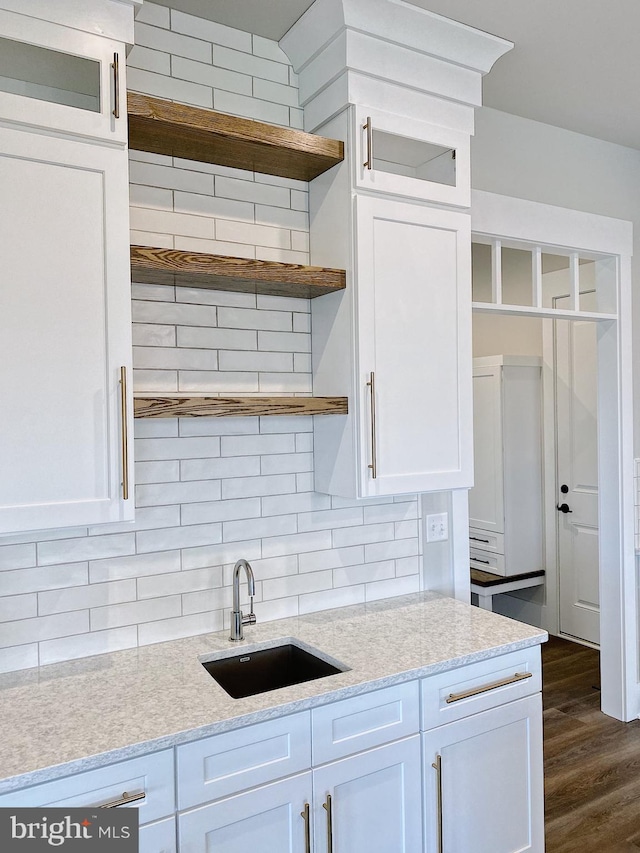 kitchen with white cabinetry, tasteful backsplash, and dark wood-type flooring