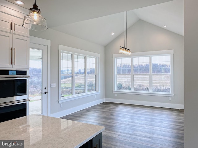 kitchen with white cabinets, a healthy amount of sunlight, and hanging light fixtures