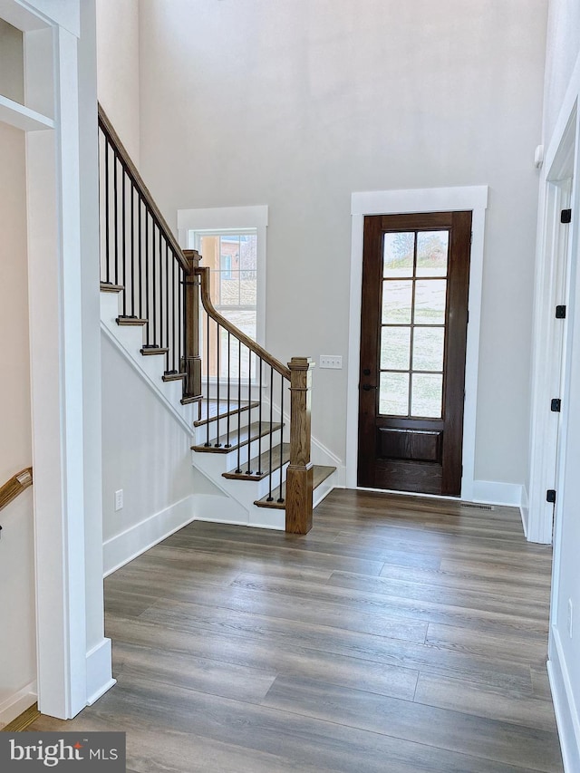 foyer with a healthy amount of sunlight and dark hardwood / wood-style floors