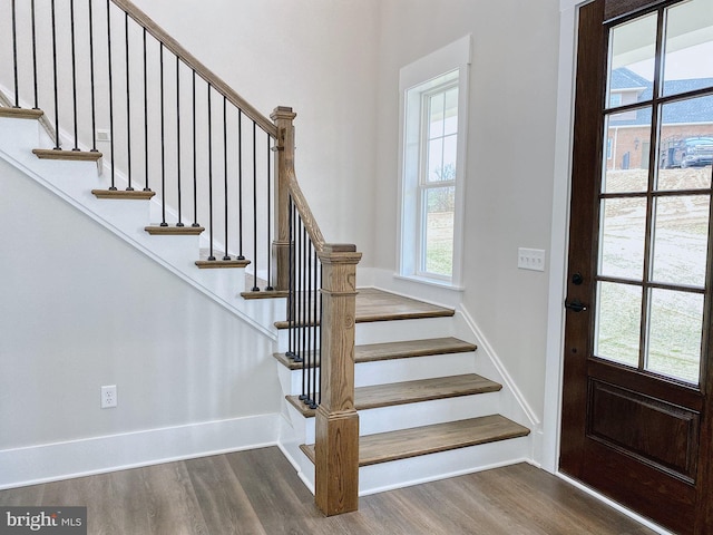 entryway with dark hardwood / wood-style flooring