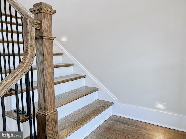 staircase with hardwood / wood-style floors