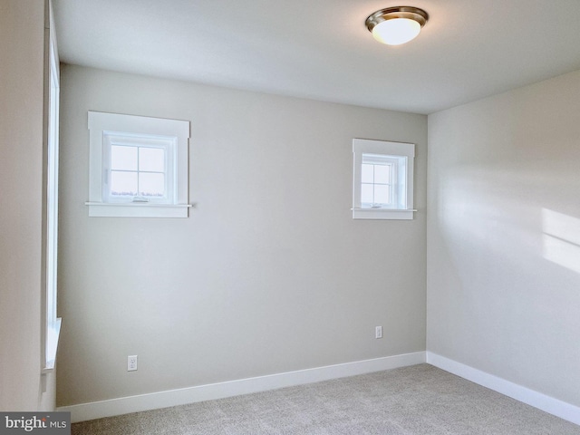 carpeted empty room with a healthy amount of sunlight