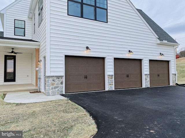 view of property exterior with a garage and ceiling fan