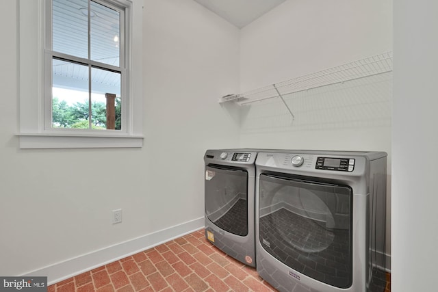 washroom with washing machine and clothes dryer