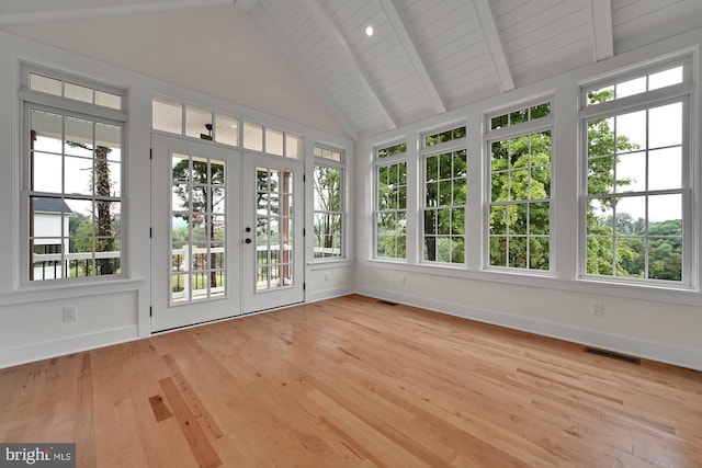 unfurnished sunroom with french doors, vaulted ceiling with beams, and plenty of natural light