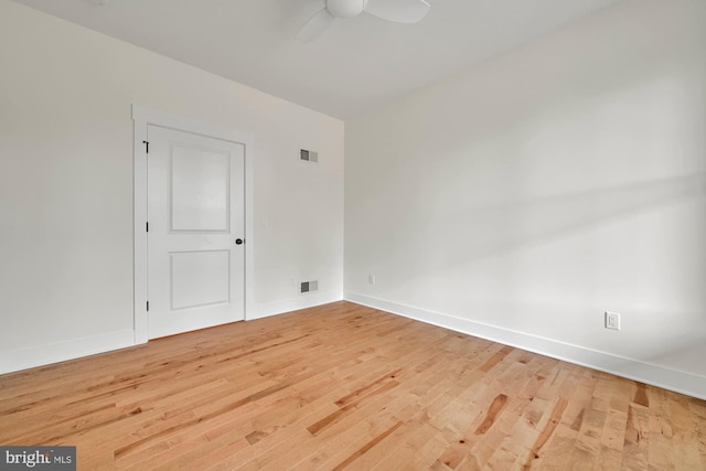 empty room with ceiling fan and hardwood / wood-style flooring