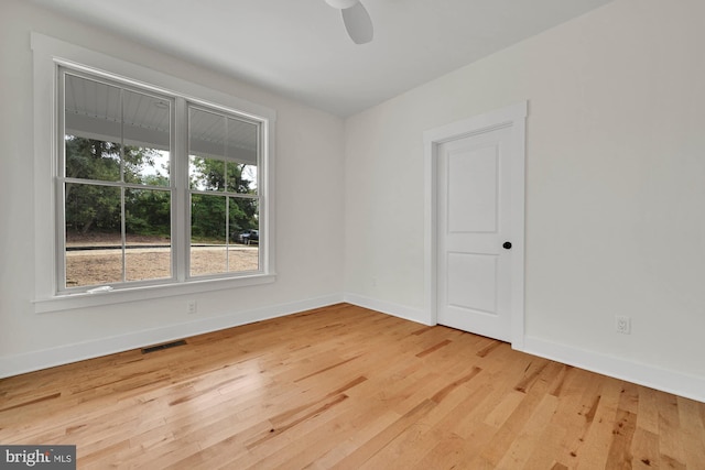 empty room featuring hardwood / wood-style floors and ceiling fan