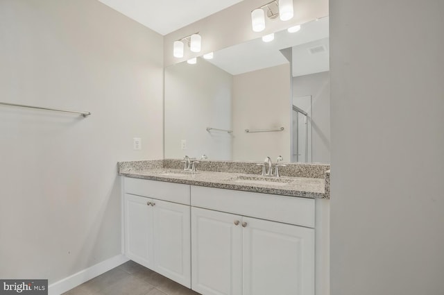 bathroom with vanity, tile patterned floors, and a shower with door