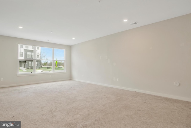 empty room featuring light carpet