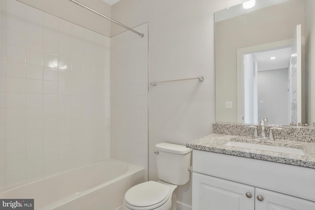 full bathroom with vanity, tiled shower / bath combo, and toilet