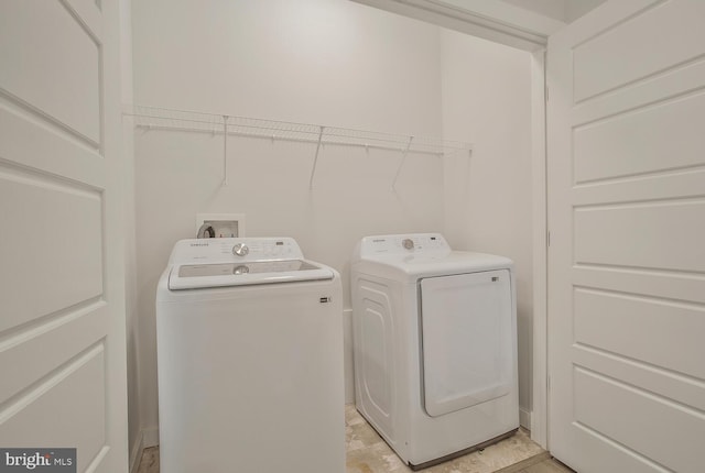 clothes washing area featuring independent washer and dryer