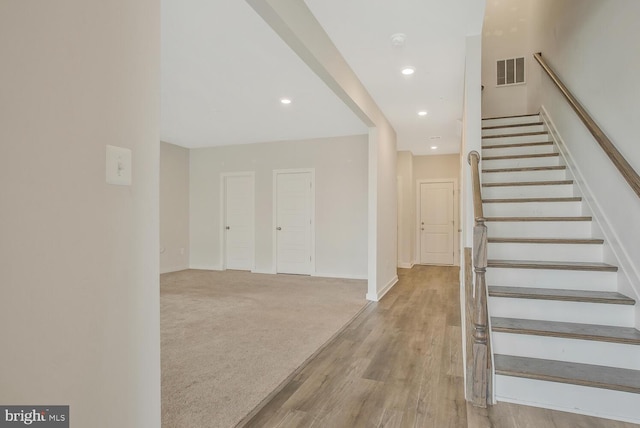 stairway featuring hardwood / wood-style floors