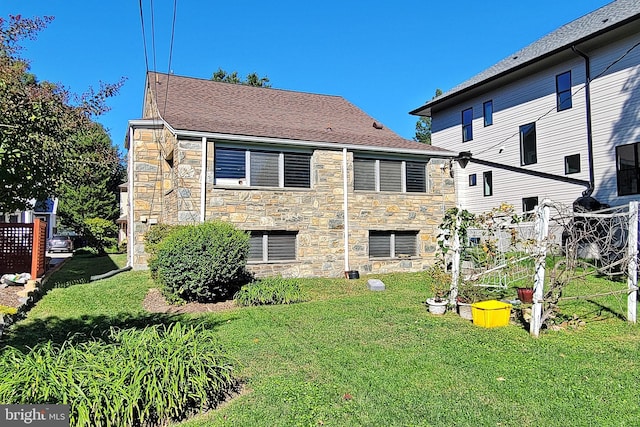 rear view of house with a yard