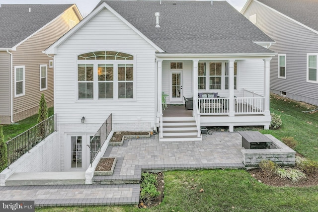 rear view of house featuring a lawn