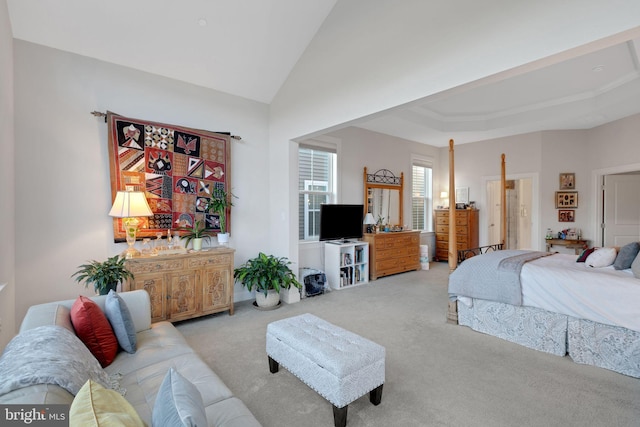 bedroom with light colored carpet and lofted ceiling