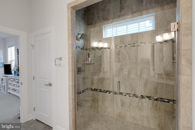 bathroom with a shower with shower door