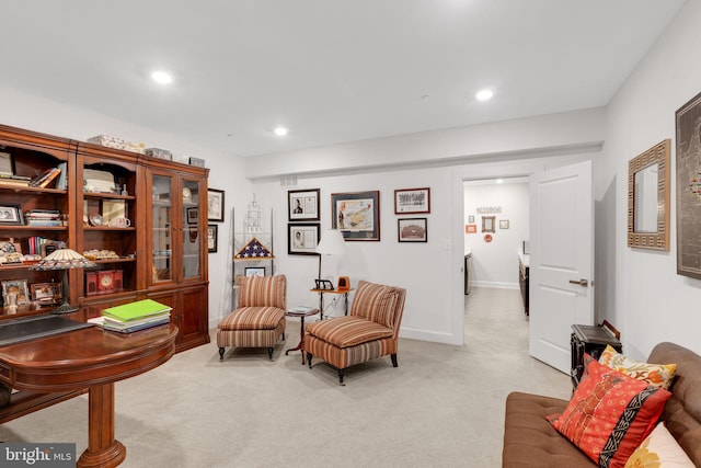 living area featuring light carpet