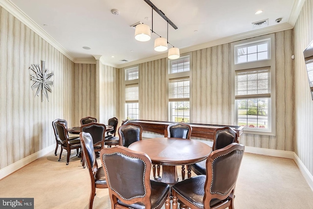 carpeted dining room with crown molding