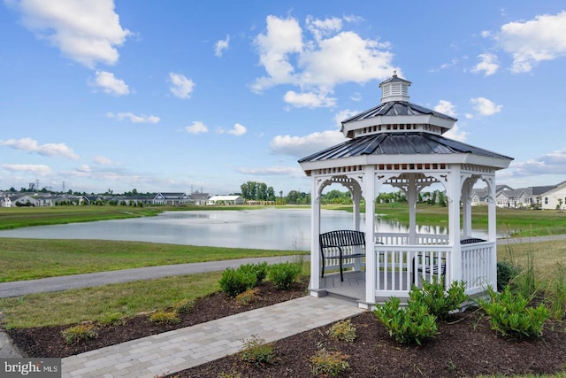 exterior space featuring a gazebo, a water view, and a yard