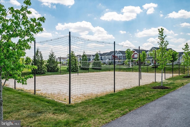 view of property's community featuring volleyball court and a lawn