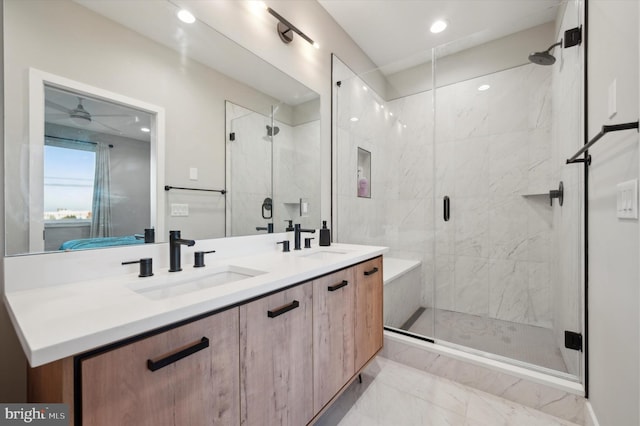 bathroom with vanity, ceiling fan, and an enclosed shower