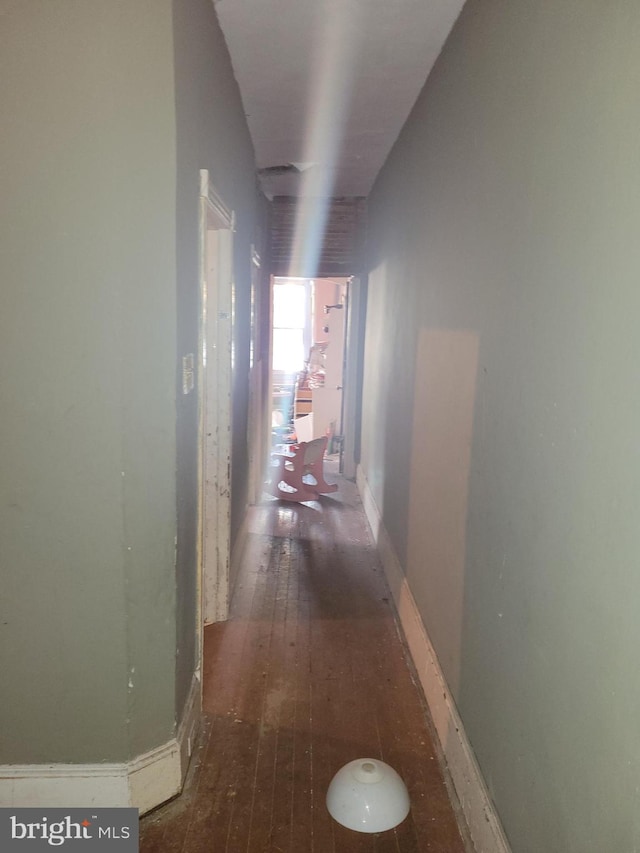 hall featuring dark wood-type flooring and lofted ceiling