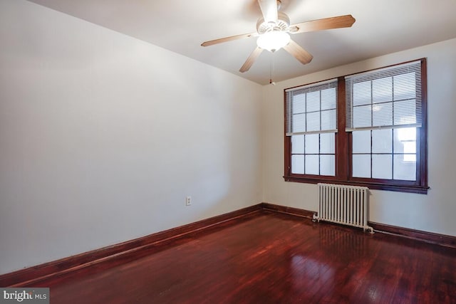 unfurnished room with radiator, ceiling fan, and wood-type flooring