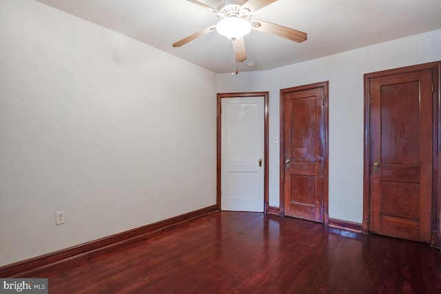 unfurnished bedroom with dark wood-type flooring and ceiling fan