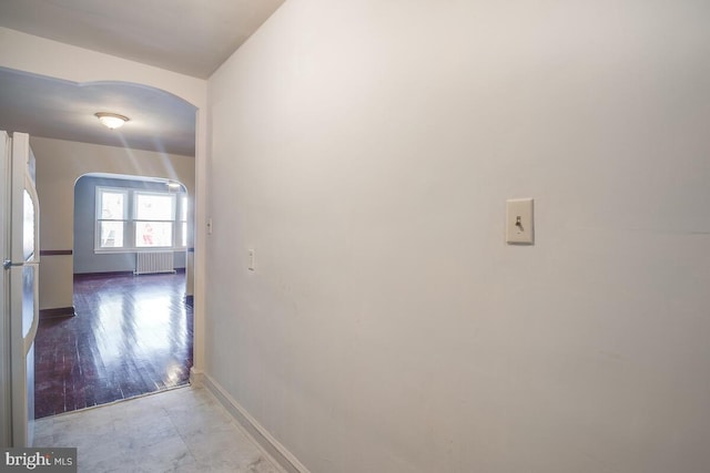 hall featuring light hardwood / wood-style floors and radiator heating unit