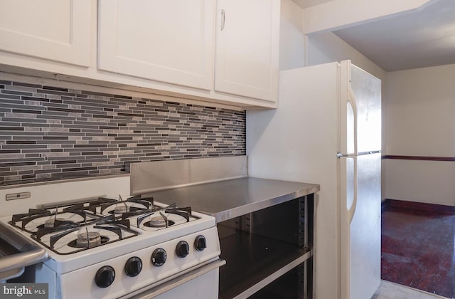 kitchen with white cabinetry, white appliances, and tasteful backsplash