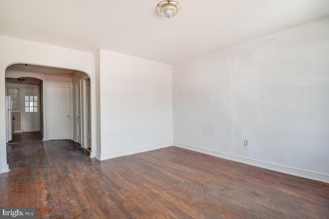 spare room with dark wood-type flooring