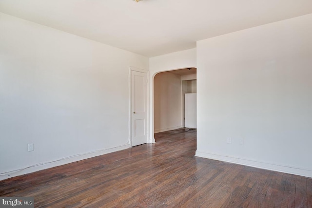 spare room featuring dark hardwood / wood-style flooring