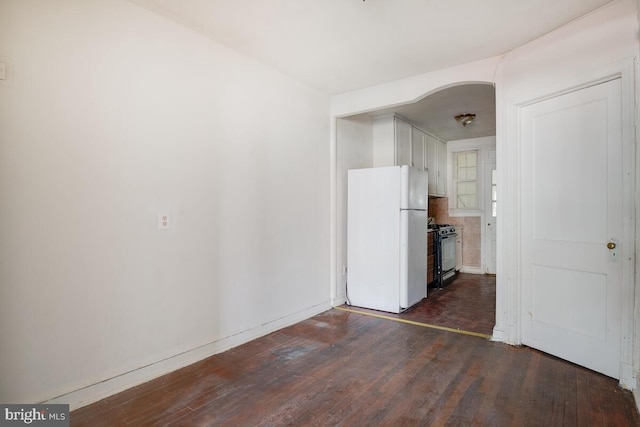 spare room with dark wood-type flooring